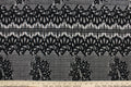 This lace features a floral design in black with a stretch.