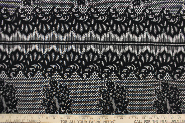 This lace features a floral design in black with a stretch.