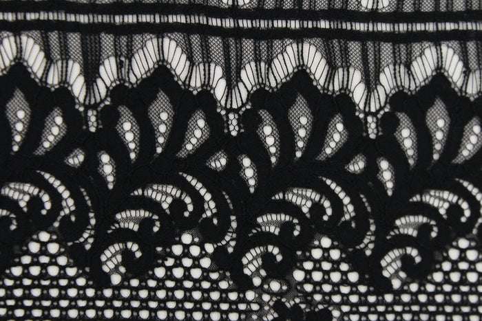 This lace features a floral design in black with a stretch.
