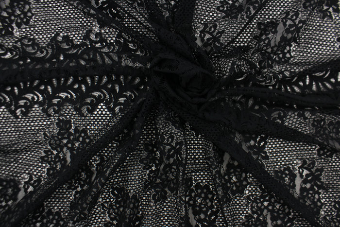 This lace features a floral design in black with a stretch.