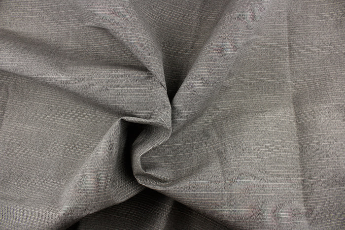 A grayish brown fabric great for umbrellas, outdoor upholstery and more.
