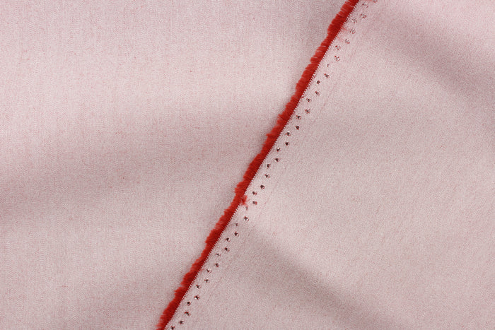 This fabric in a solid light color with hits of a rust red color is great for umbrellas, outdoor upholstery and more.