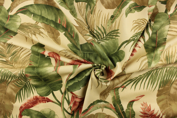 This fabric features a floral design of tropical leaves in green, brown, and rust red against a khaki color.