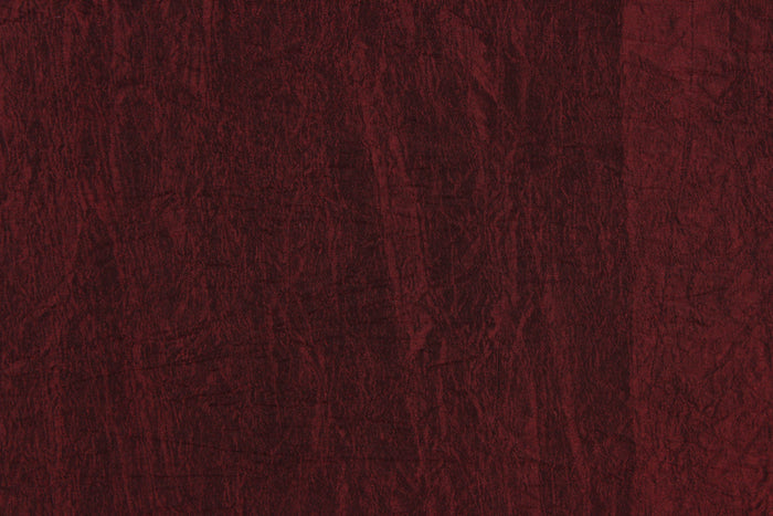 This taffeta fabric features a crinkle in iridescent deep red.