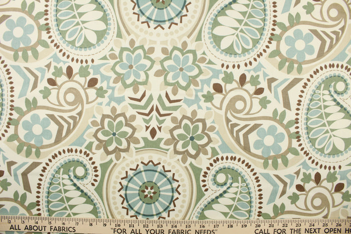 This fabric features a paisley floral design in light blue, moss green, brown, taupe, and pale beige set against a off white.