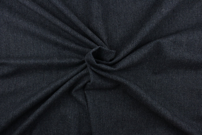 This wool features a herringbone design in blue and gray