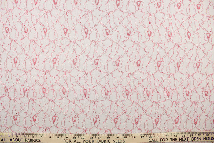 This lace features a woven floral design in white with red outline.