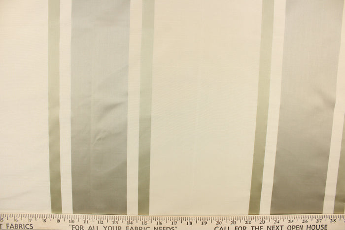 This stunning yarn dyed fabric features a striped pattern in cream or light khaki and silver.