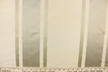 This stunning yarn dyed fabric features a striped pattern in cream or light khaki and silver.