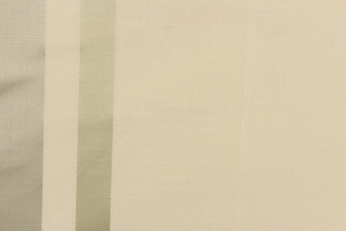 This stunning yarn dyed fabric features a striped pattern in cream or light khaki and silver.
