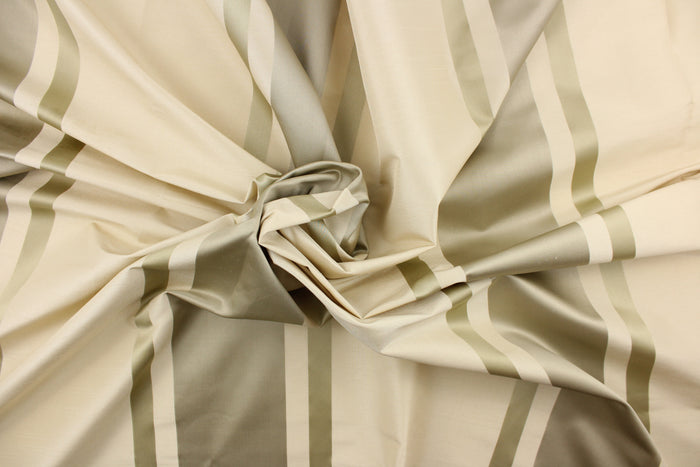 This stunning yarn dyed fabric features a striped pattern in cream or light khaki and silver.