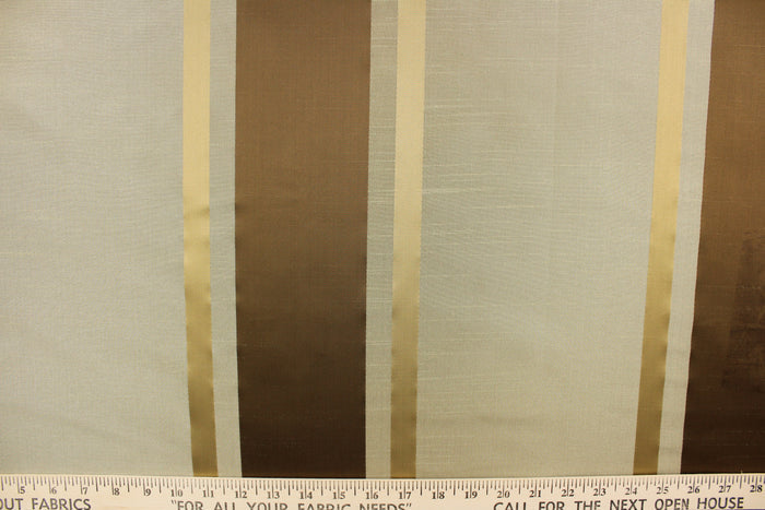 This stunning yarn dyed fabric features a  striped pattern in rich brown tones, gold and taupe.