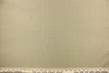 This yarn dye stripe fabric features a small plaid or checkered design in light khaki and pale green.